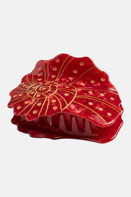 Pince à cheveux rouge de PIECES®, avec décoration en spirale de couleur or et pois.