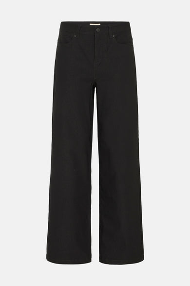 Chino noir de France, avec des poches à l'arrière et des jambes larges.