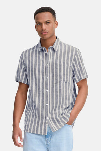 Chemise rayée bleue de SOLID, à manches courtes et portée avec un jean bleu clair et des baskets blanches.