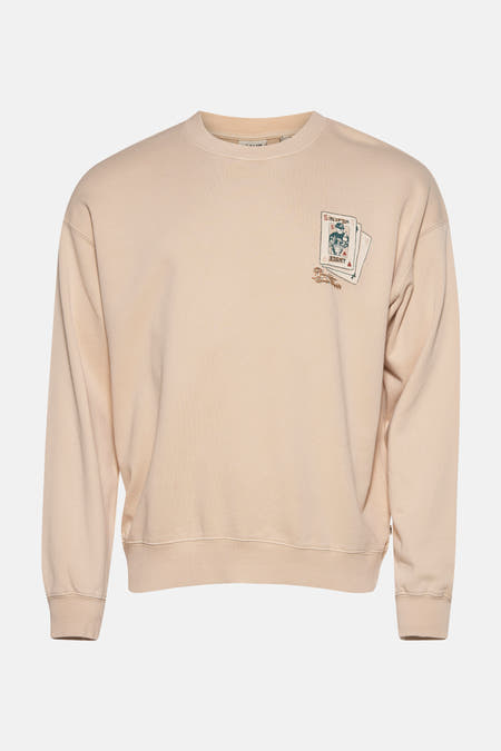 Ecru sweater van SOLID, met een print van speelkaarten op de borst.
