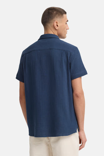 Blauw overhemd met korte mouwen van SOLID, met crêpetextuur, vanaf de achterkant gezien, gedragen op een lichte broek.