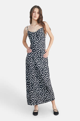 Robe sans manches noire de 24 couleurs, avec une impression de fleurs blanches et une fente.