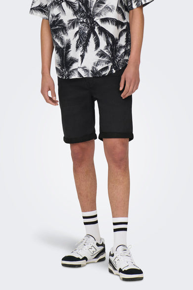 Persoon in palmboomhemd, zwarte shorts, gestreepte sokken en New Balance sneakers.