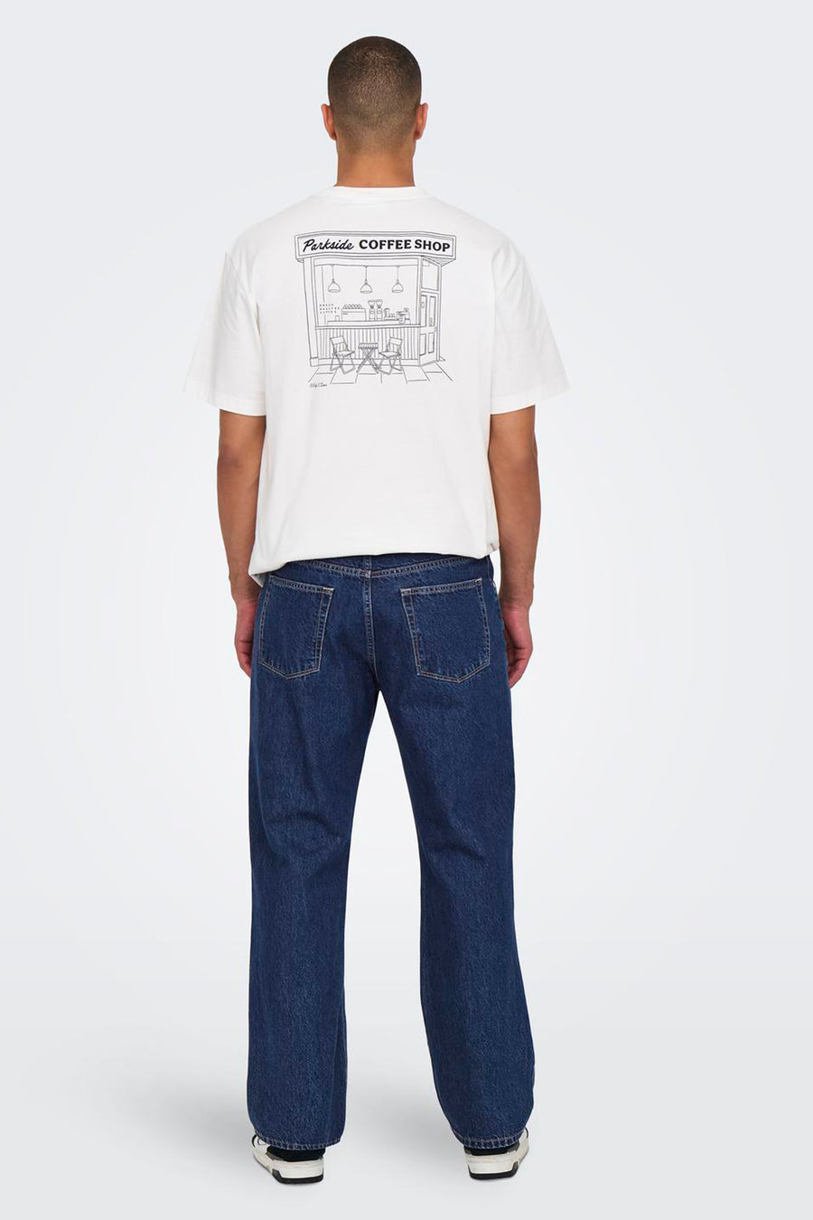 Donkerblauwe wijde jeans van ONLY & SONS, gezien van achteren, gecombineerd met een wit T-shirt met print.