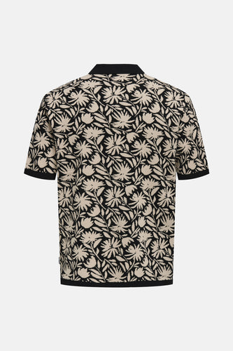 Poloshirt met bloemenprint, zwarte boorden.