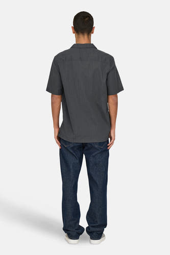 Chemise grise à manches courtes de ONLY & SONS, vue de derrière, avec des jeans foncés et des chaussures blanches.