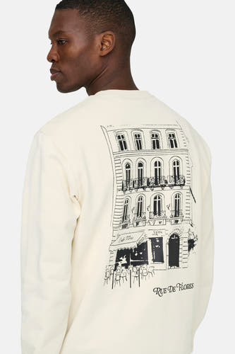 Pull blanc à col rond ONLY & SONS, avec une illustration de bâtiment au dos.