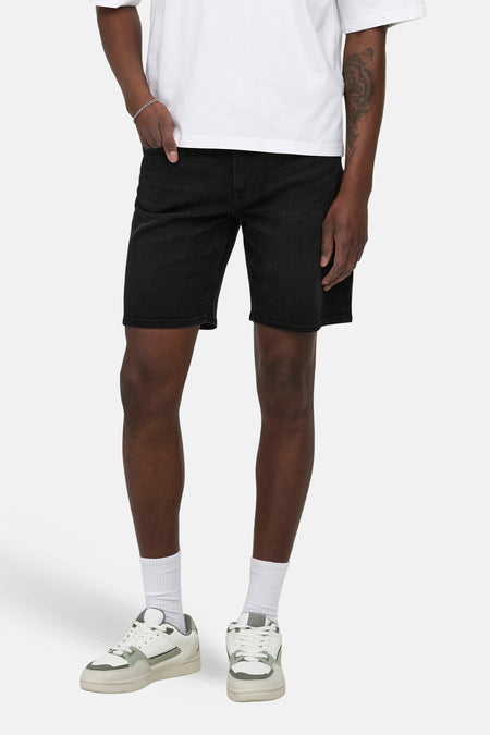 Zwarte jeansshort van ONLY & SONS, met witte sokken en lage sneakers.