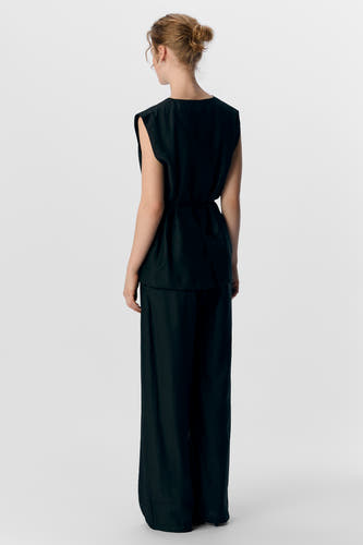 Pantalon noir d'OBJECT, vu de l'arrière, avec une coupe décontractée et des jambes longues.