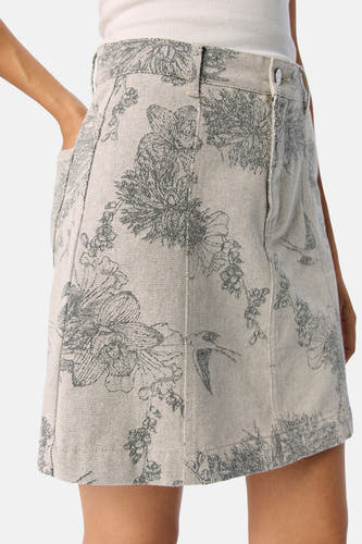Jupe courte écru d'OBJECT avec motif de fleurs et d'oiseaux, poche visible et fermeture à bouton.