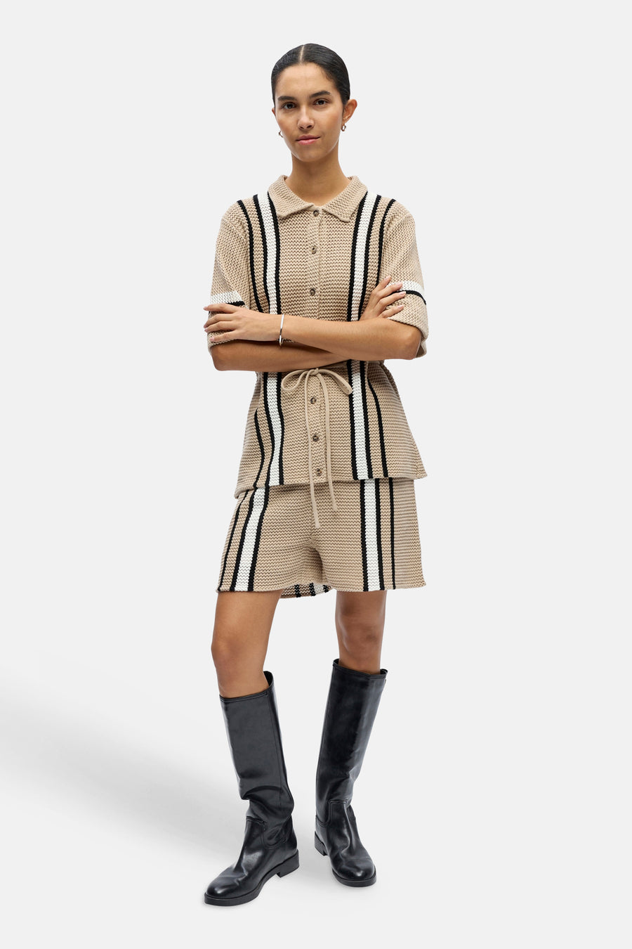 Beige gebreid hemd met korte mouwen van OBJECT, met verticale zwarte en witte strepen en kraag, gedragen met bijpassende shorts en laarzen.