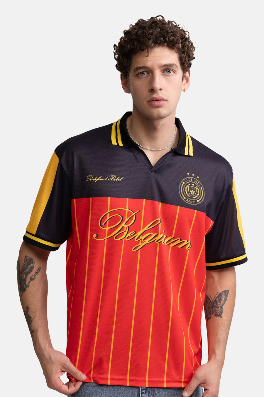 Multicolor polo met rode en zwarte panelen en gele strepen, van REDEFINED REBEL, met 'Belgium' logo en korte mouwen, front view