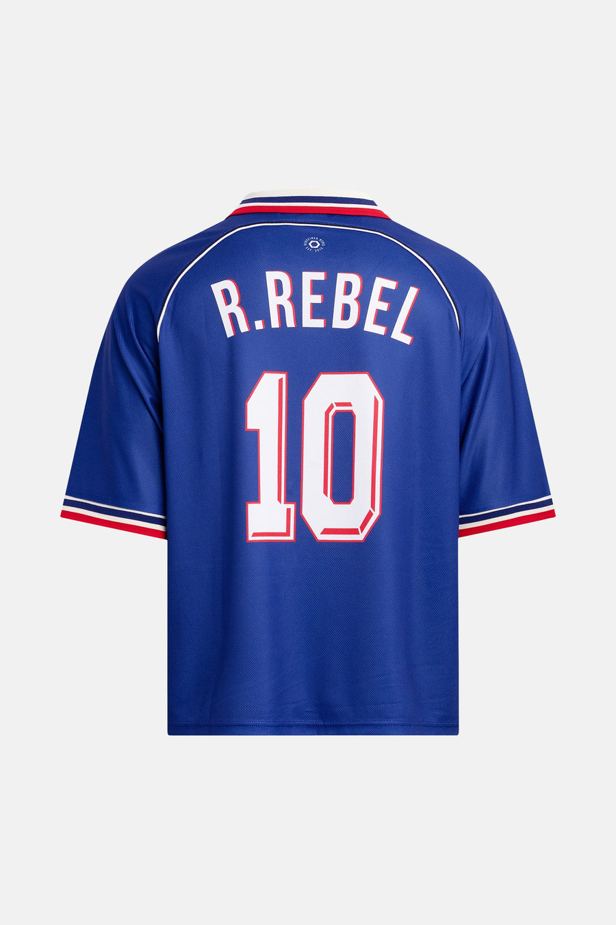 Blauwe polo van REDEFINED REBEL met witte "R.REBEL" en nummer 10, rode en witte accenten op mouwen en kraag, achterkant weergave