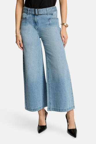 Lichtblauwe wijde jeans van Morgan De Toi, met riem en zwarte pumps.
