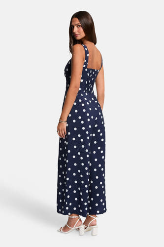 Blauwe jumpsuit van Morgan De Toi met witte stippen, smockwerk op de rug en wijde pijpen.
