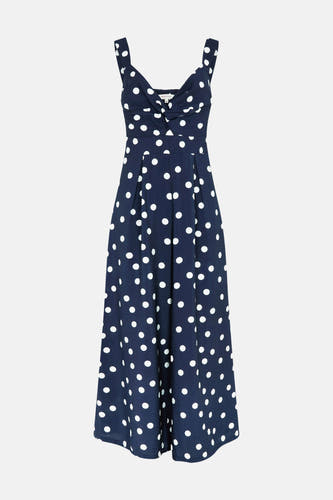 Donkerblauwe jumpsuit van Morgan De Toi met witte stippen, een knoopdetail bij de buste en wijde pijpen.
