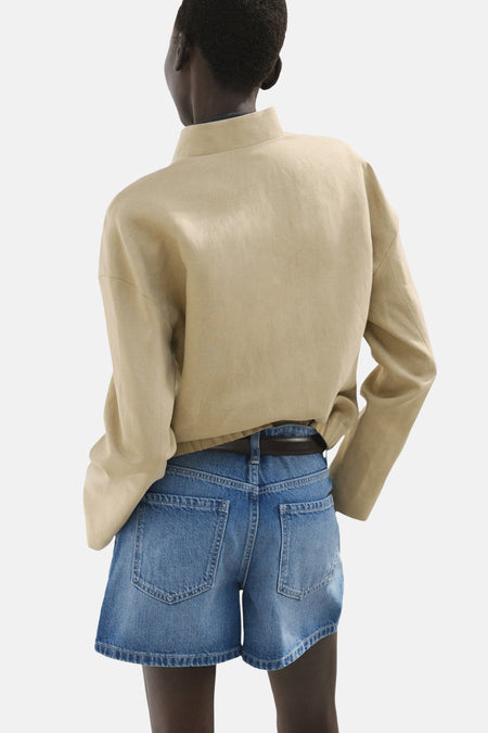 Denim bermuda short in middenblauw denim van MANGO, met donkerbruine riem en achterzakken, rugzijde.