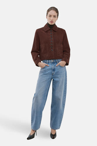 Jeans special fit van lichtblauw denim van MANGO, gecombineerd met een bruine jas en zwarte schoenen.