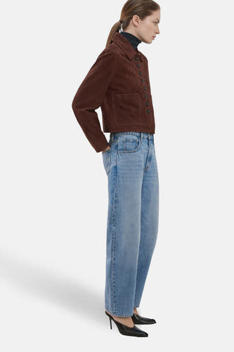 Lichtblauwe denim jeans special fit van MANGO, met wijde pijpen en gedragen met een bruin suède jack.
