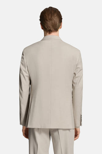 Blazer beige de MANGO, vu de dos, avec une texture lisse et une coupe soignée.