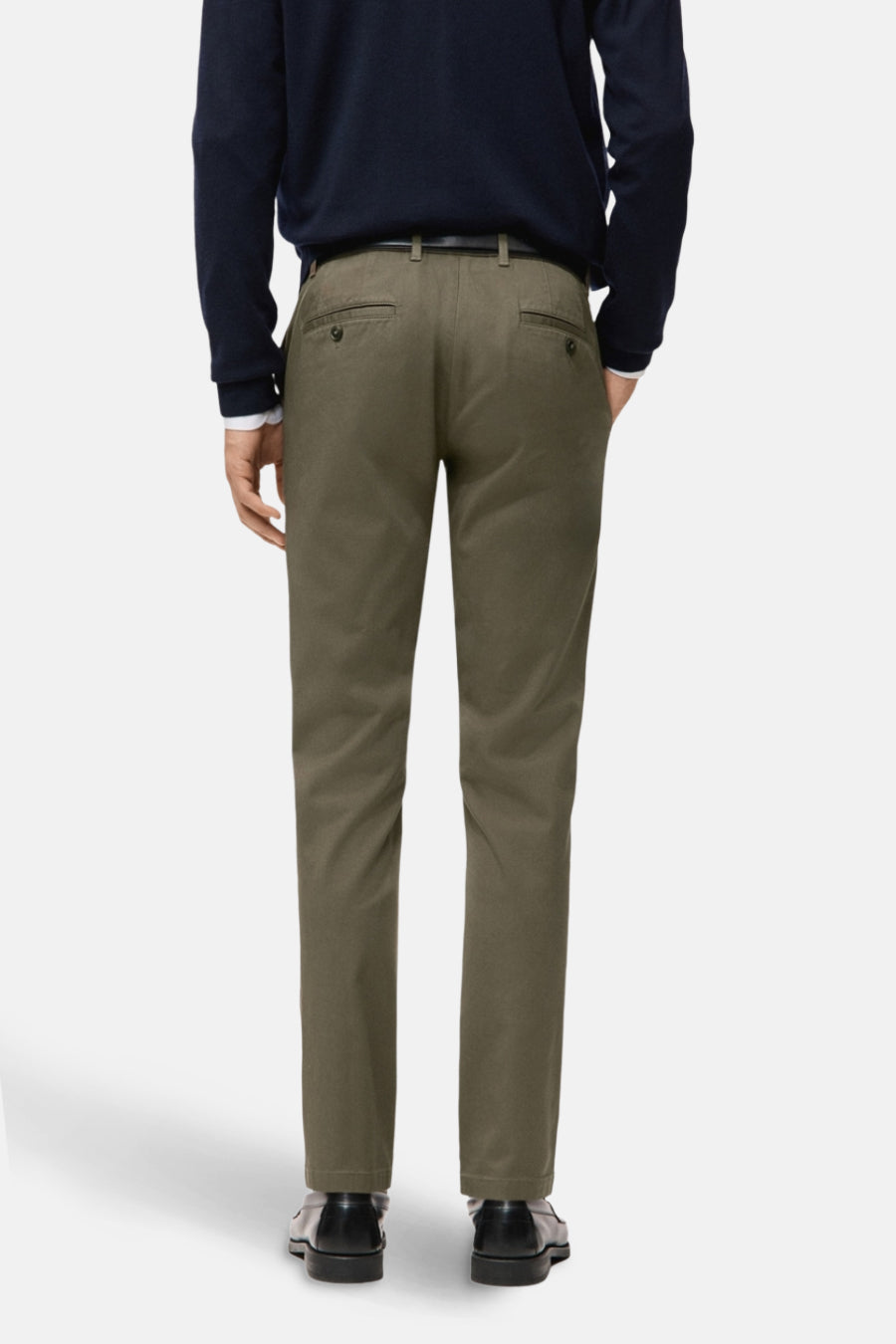 Groene chino van MANGO, gezien van achteren, met een donkerblauwe trui en zwarte schoenen.
