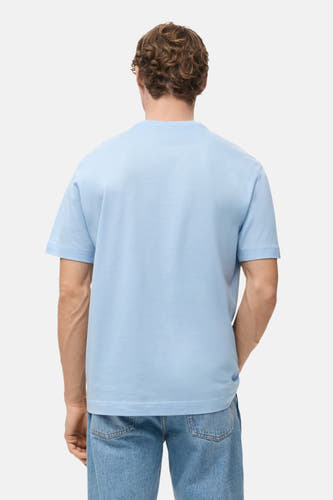 Blauw T-shirt met korte mouwen van MANGO, gezien van achteren, gecombineerd met een blauwe jeans.
