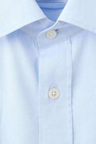 Chemise bleue à manches longues de MANGO, gros plan avec col et boutons.
