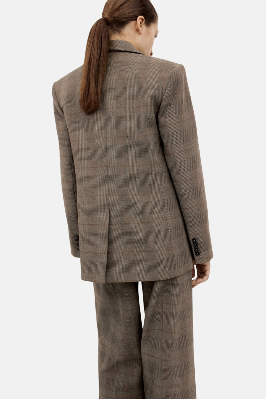 Bruine blazer van MANGO, met een ruitpatroon en knoopdetails op de mouwen, gezien van achteren.
