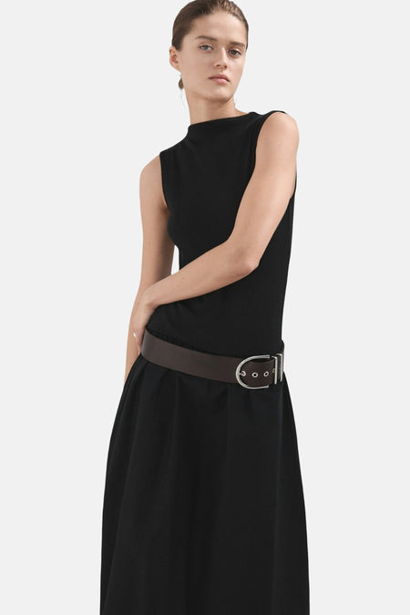 Robe noire sans manches de MANGO, finie avec une ceinture marron.