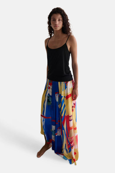Jupe longue multicolore de MANGO avec motif abstrait bleu, jaune et rouge, suspendue.