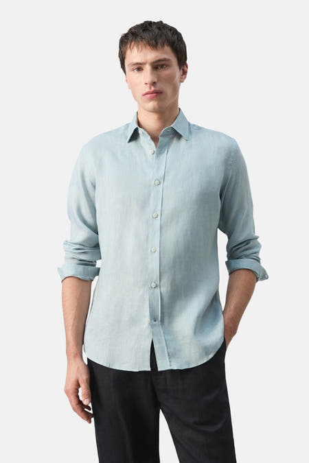 Chemise bleue à manches longues de MANGO, vue de dos, avec une texture subtile et des manches longues.