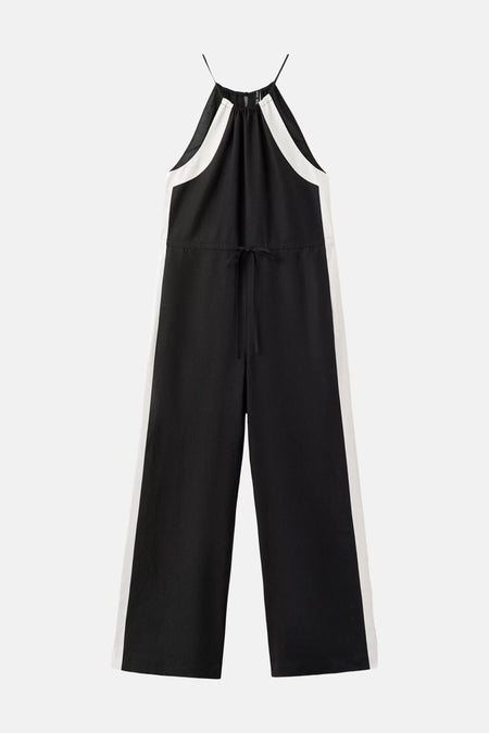 Combinaison noir et blanc de MANGO avec col licou, fines bretelles, cordon de serrage à la taille et jambes larges.