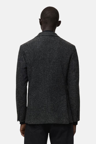 Multikleurige blazer van MANGO, gezien van achteren, met een subtiel patroon en slanke pasvorm.