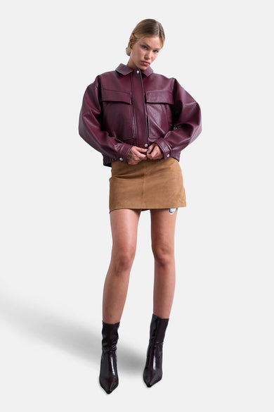 Korte bordeaux jas van TOPSHOP, gedragen met een bruin suède rokje en bruine enkellaarsjes.