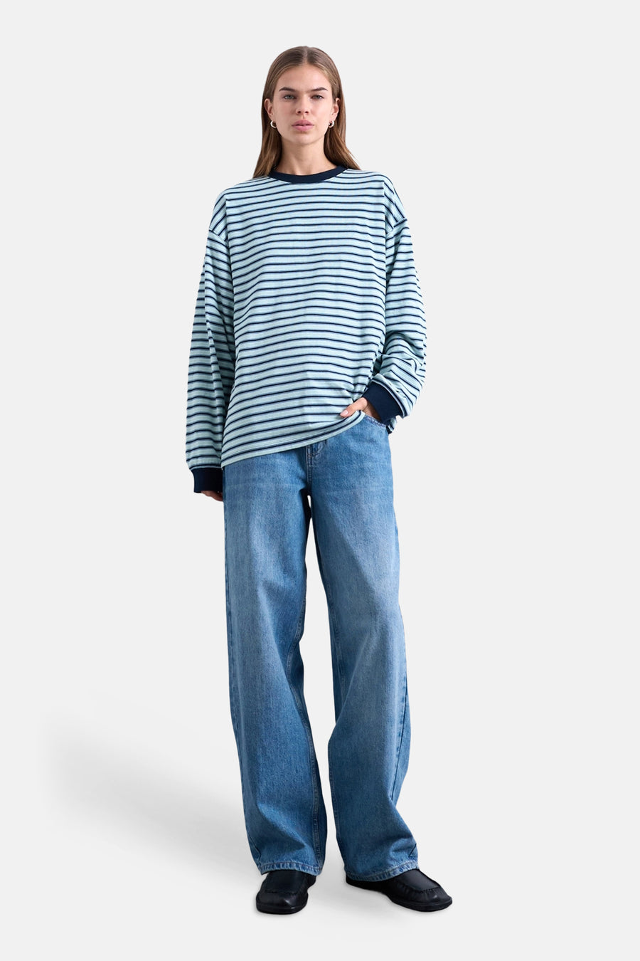 T-shirt multicolore à manches longues TOPSHOP, à rayures horizontales, associé à un jean ample et des chaussures noires.