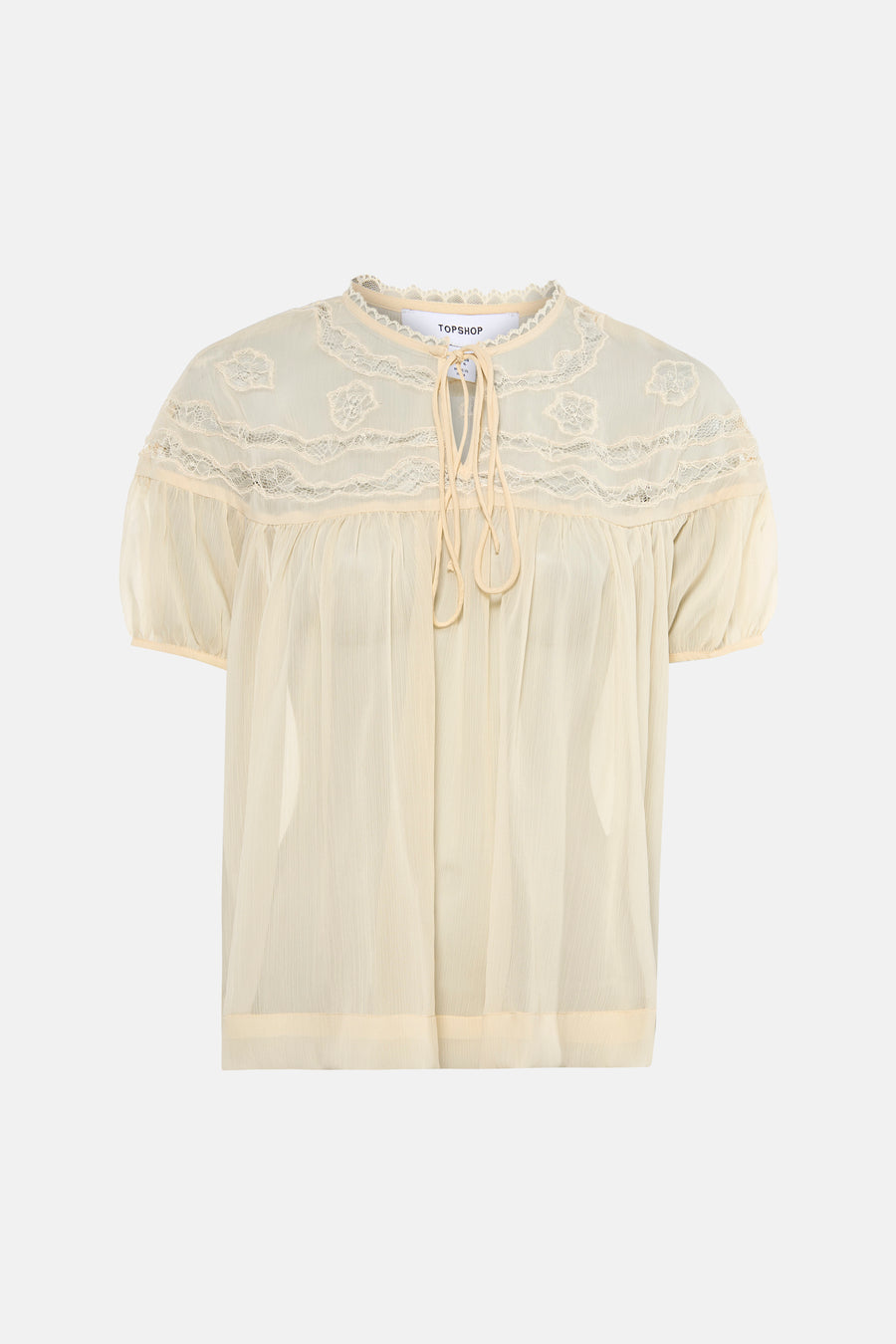 Blouse écru transparente à manches courtes de TOPSHOP, avec détails en dentelle et fermeture à nouer au col.