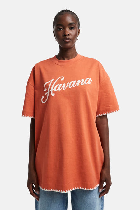 Oranje T-shirt met korte mouwen van TOPSHOP, met witte opdruk "Havana" en witte zigzag randafwerking.