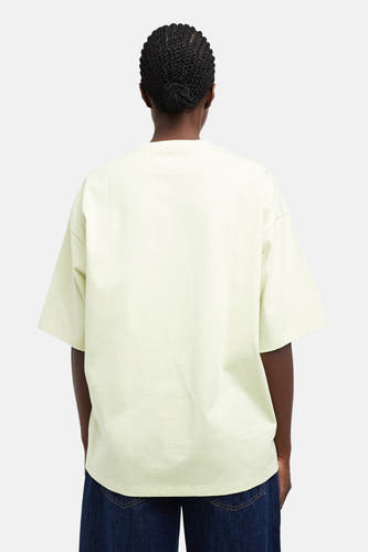 Groene oversized T-shirt van TOPSHOP, achterkant, lichte stof, model met donkere jeans, rugzicht
