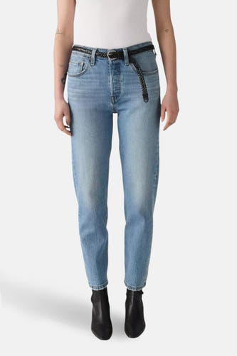 Lichtblauwe straight jeans van Levi's, gestyled met een gevlochten riem en zwarte laarzen.
