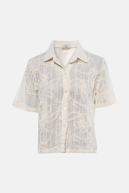 Chemisier beige à manches courtes de Terra di Siena, avec motif floral et fermeture à boutons.