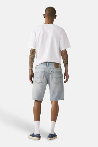 Lichtblauwe denim shorts van Levi's®, achterzijde, met klassieke zakken en vervaagde was, model draagt wit T-shirt en witte sokken.