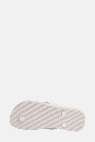 Chaussons blancs Havaianas avec un profil de semelle rayé et des détails de reliure ronds.
