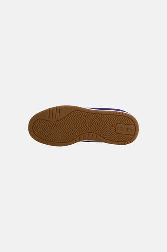 Baskets bleues de PUMA, avec une semelle marron à motif zigzag.