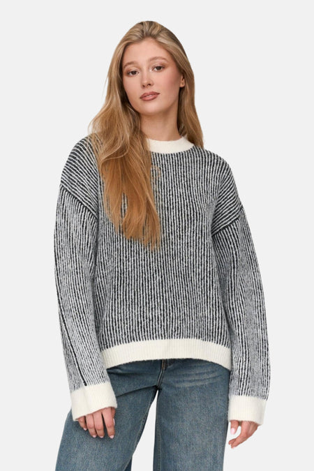 Vrouw in gestreepte trui en jeans.