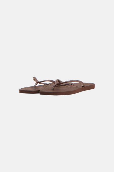 Bruine slippers van Havaianas met glimmende bandjes en een gestreepte zool.