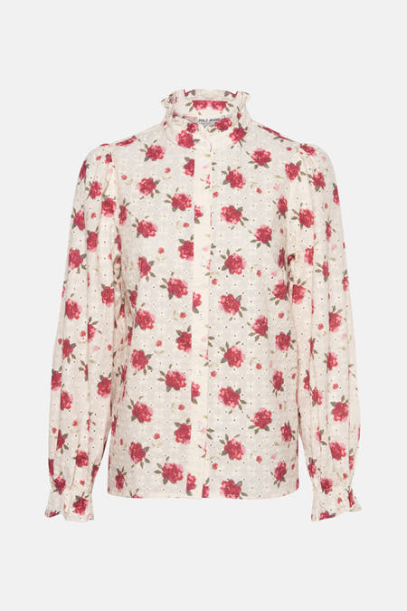Blouse blanche à longues manches de PULZ, avec un motif de roses et des détails ajourés.