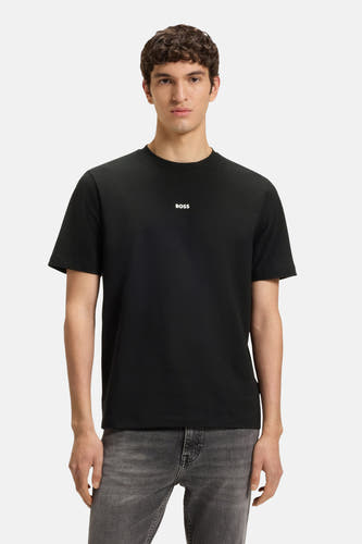 T-shirt noir à manches courtes de HUGO BOSS ORANGE, porté avec un jeans gris.