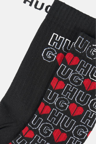 Meerkleurige sokken multipack van HUGO, met een "HUG" logo en rode harten patroon.
