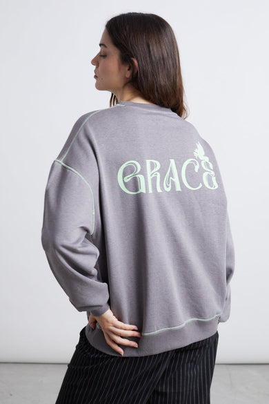 Gilet gris de 24 couleurs avec col rond, texte "GRACE" sur le dos et points verts clairs.