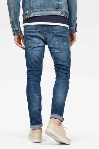 Jean skinny en denim bleu moyen van G-Star RAW, avec des poches arrière et des ourlets de pantalon rabattus, dos.
